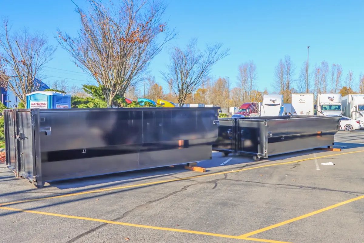 Professional dumpster rental service with roll-off container on residential driveway in Hempfield